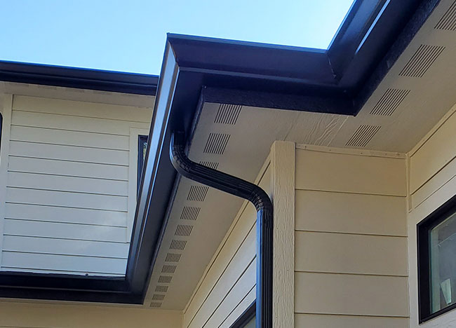 home-final-section brown gutter and drain spout on light house Rain Master Seamless Rain Gutters in Coeur d'Alene, ID